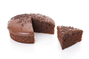 Sliced chocolate fudge cake isolated on white background.