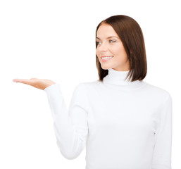 woman in white sweater with something on palm