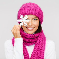 woman in hat and muffler with big snowflake