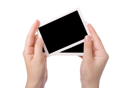 Hand holding a photograph isolated on a white background.