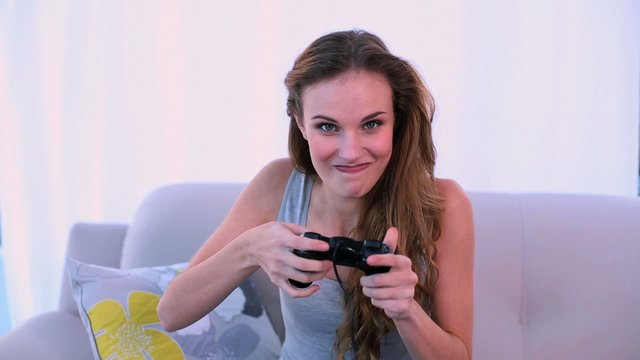 Happy model playing video games on the couch