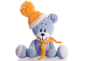 teddy bear with  scarf and bobble cap in winter