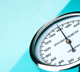 Sphygmomanometer on blue, reflective background