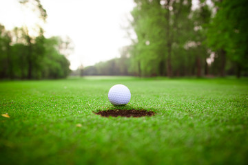 golf ball on lip of cup