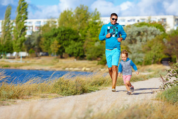 father and son running in city park, healthy lifestyle