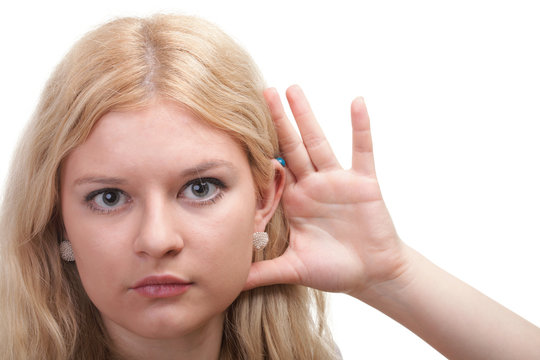 woman eavesdropping with hand behind her ear
