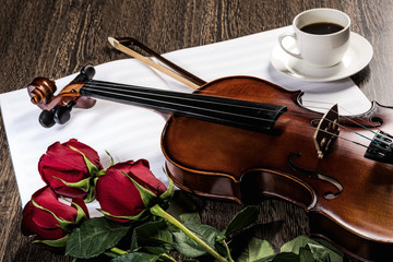 Fototapeta premium Violin, rose, coffee and music books