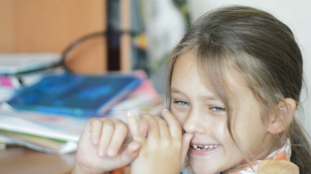kid fooling around, twisting her fingers in the nose