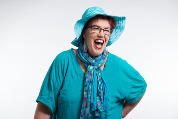 Happy smiling middle aged woman with red short hair and glasses.