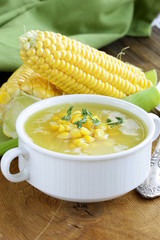 soup of fresh yellow corn served on a wooden table © Olga Kriger