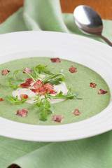 Arugula cream soup with sour cream and bacon