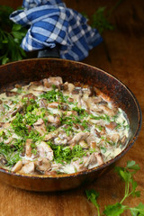 fried mushrooms with cream in a pan