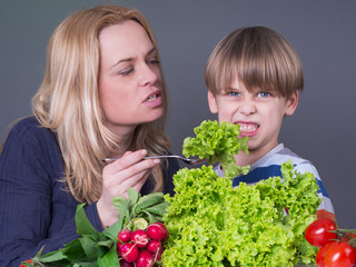 Little boy refusing to eat green salad