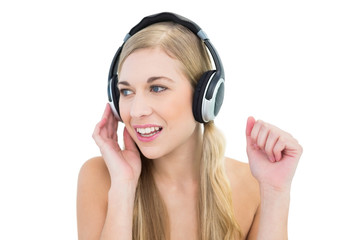 Fototapeta premium Serious young blonde woman listening to music