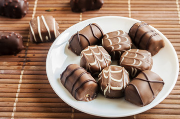 chocolate pralines on old wooden table