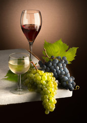 glasses of wine with grapes on the table