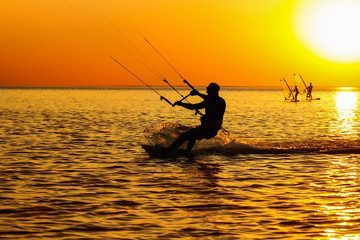 Silhouettes of a windsurfers