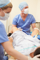 Obraz premium Woman Having Eggs Removed As Part Of IVF Treatment