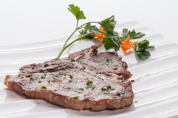 Pork chop on white dish