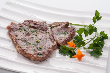 Pork chop on white dish