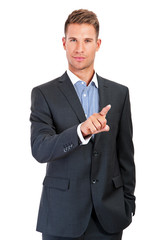 Businessman pressing an imaginary button on bokeh