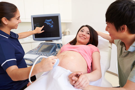 Pregnant Woman And Partner Having 4D Ultrasound Scan