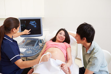 Pregnant Woman And Partner Having 4D Ultrasound Scan