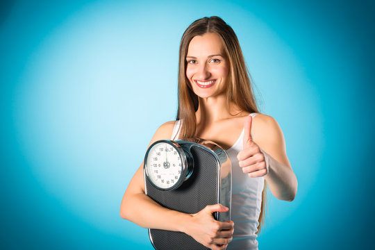 Losing weight - Young woman with measuring scale