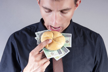 businessman is eating a sandwich with money