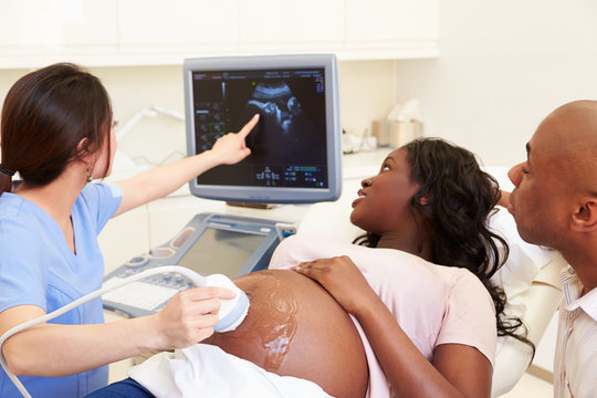 Pregnant Woman And Partner Having 4D Ultrasound Scan