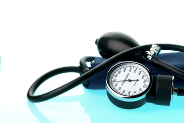 Sphygmomanometer on blue, reflective background