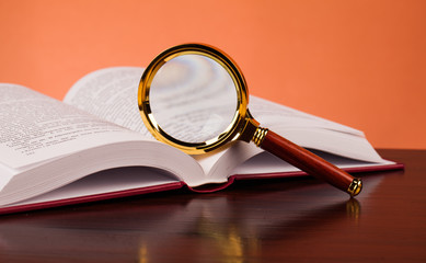 book and magnifying glass