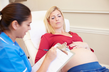 Fototapeta premium Pregnant Woman Being Given Ante Natal Check By Nurse