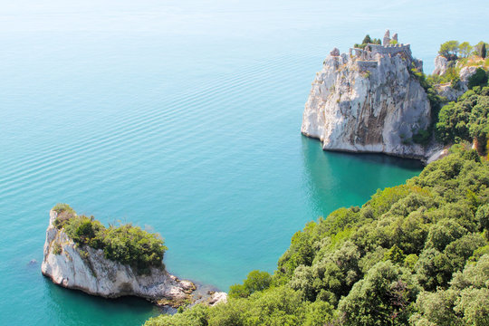 Cliffs and castle ruins on coast of Adriatic sea, Italy, Eu.