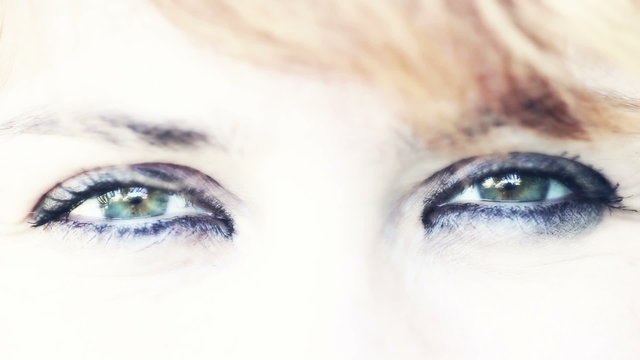 Woman give a wink. Eyes close up
