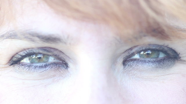 Woman give a wink. Eyes close up