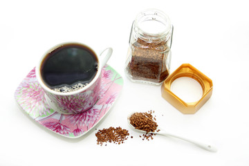 Open glass and cup with instant coffee