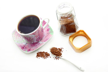 Open  jar and cup with instant coffee