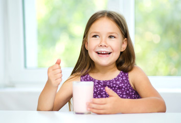 Cute little girl with a glass of milk