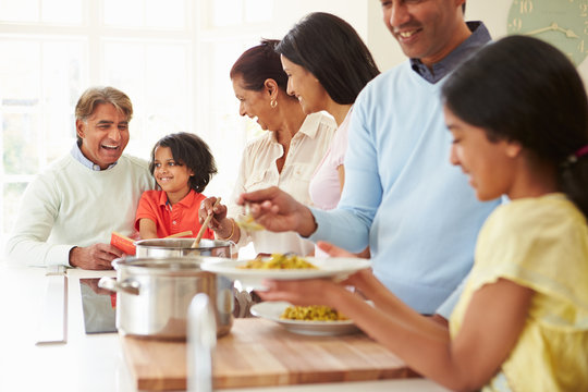 Multi Generation Indian Family Cooking Meal At Home