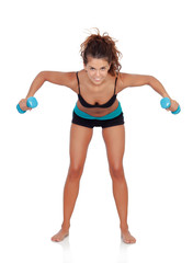 Beautiful woman doing weights to tone her muscles