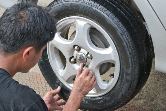 Auto Mechanic Changing Car Wheel