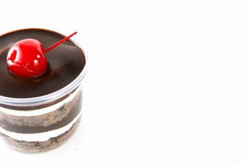 Chocolate cup cake and cherry on white background