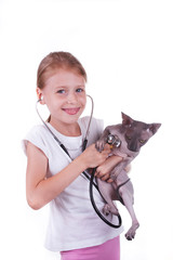 Girl playing a veterinarian with cat shpinx