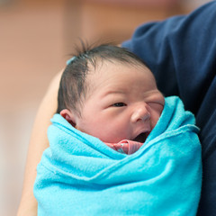 Newborn Asian baby girl and father