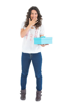 Cheerful casual brunette receiving a present