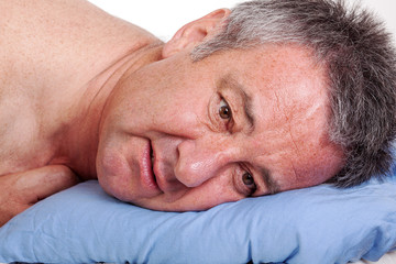 Obraz premium Man lying in bed and can not sleep