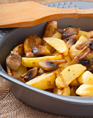 Fried potatoes with mushrooms and onions