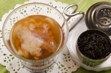 tea with milk and a tea ball