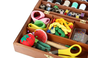 Sewing kit in wooden box isolated on white